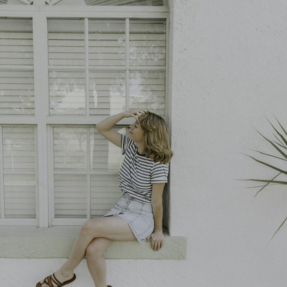 woman sitting in front of window