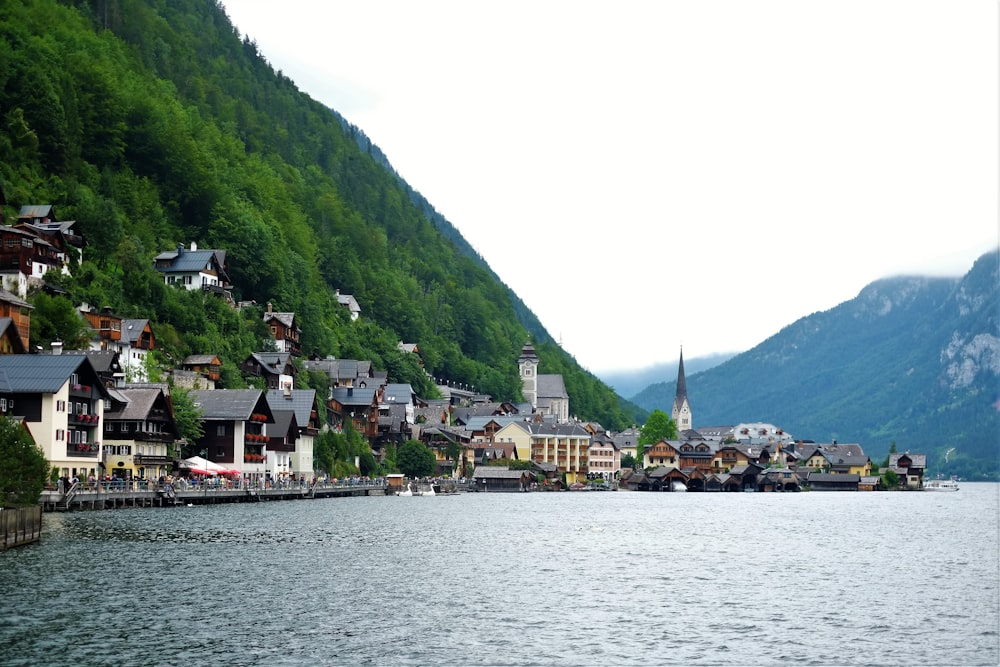 wavy of body of water near houses during daytime