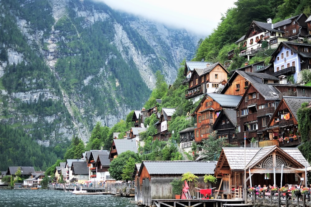 photography of buildings near mountain during daytime