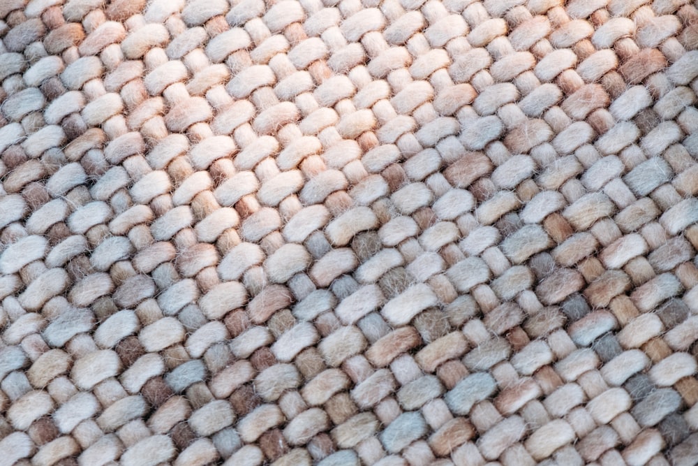 a close up of a rug with a cat laying on top of it