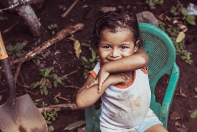 girl sitting on teal chair nicaragua teams background