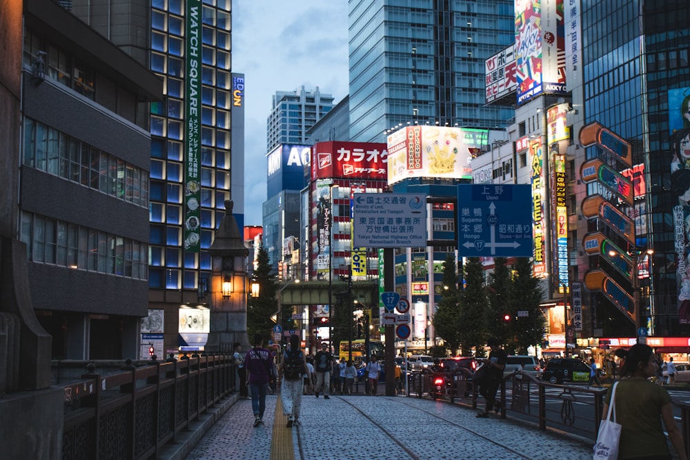 people standing between high buildings