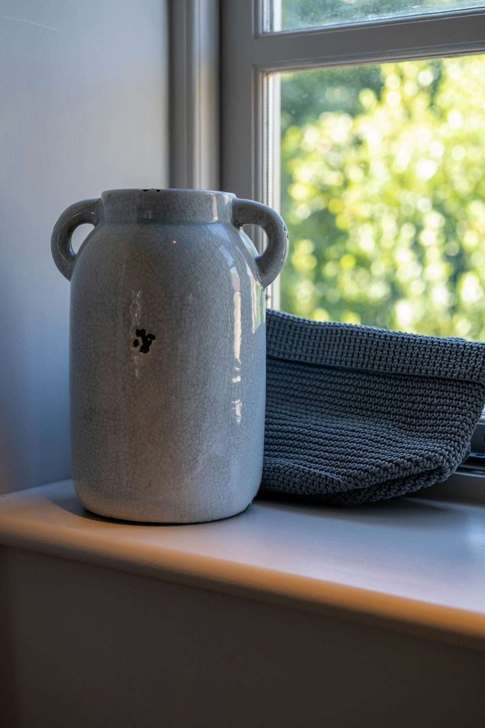 gray mug near window