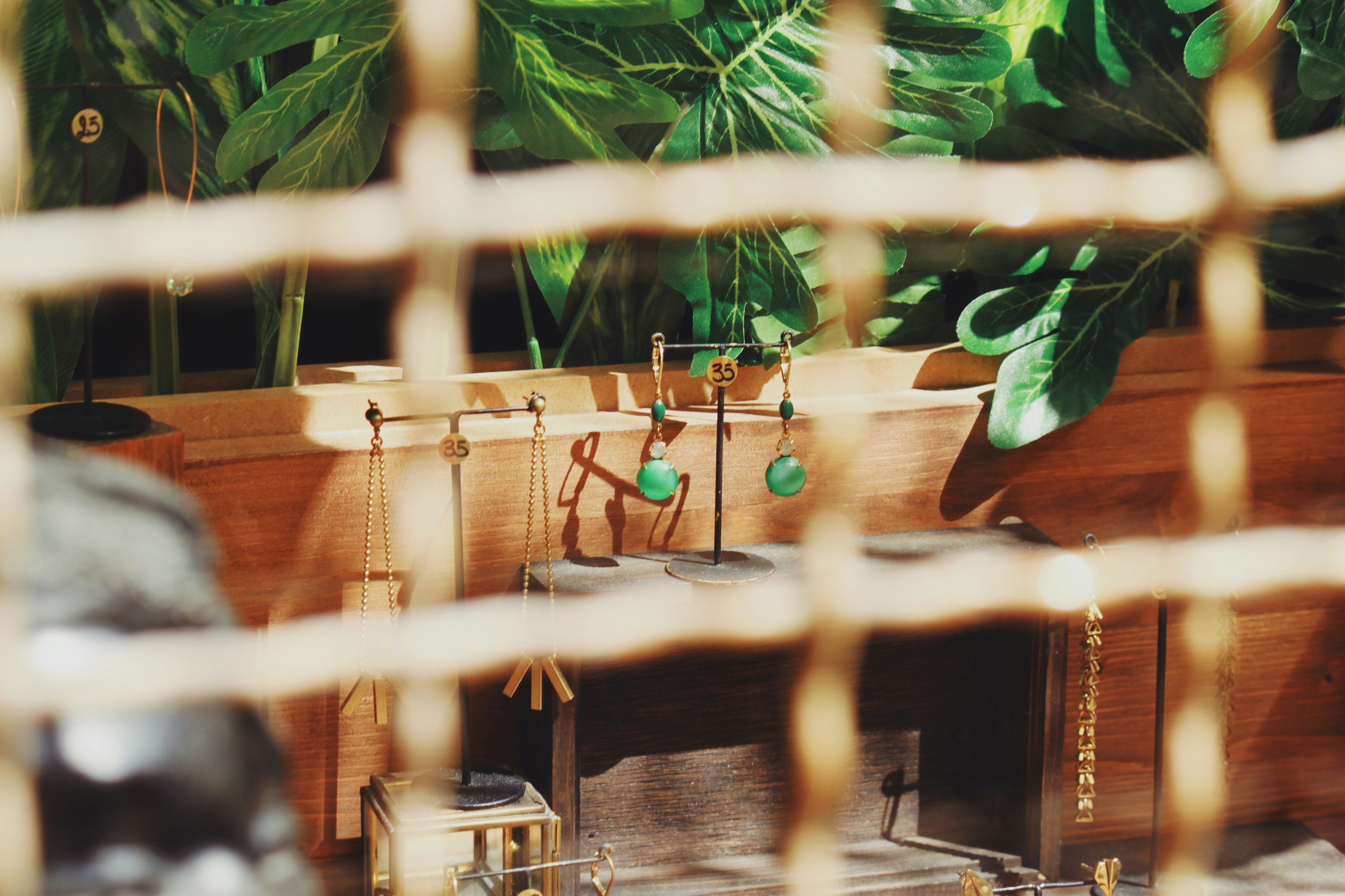 green drop earrings in jewelry rack