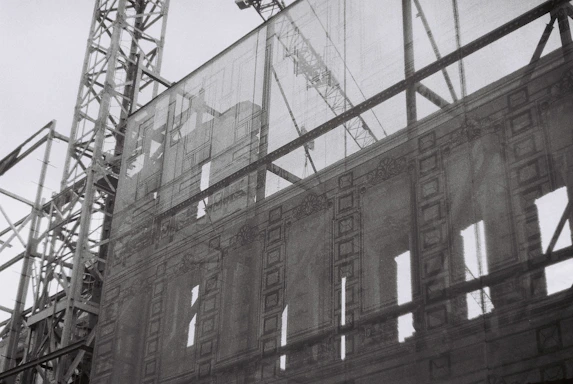Elegant black and silver-themed construction site showcasing a senior architect reviewing blueprints.
