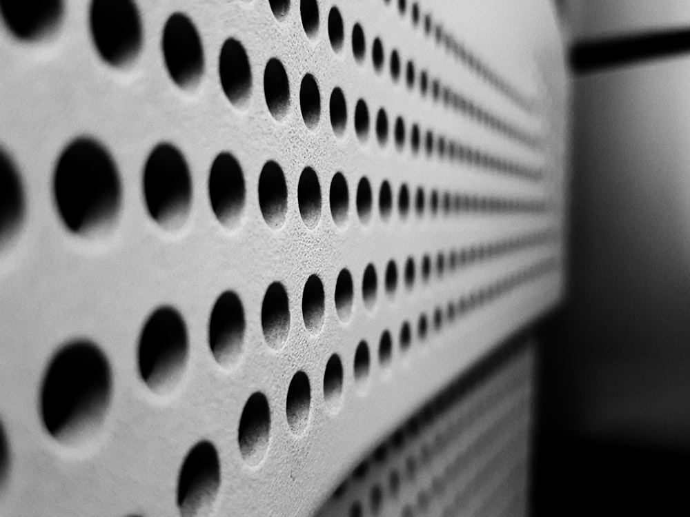 a close up of a wall with holes in it