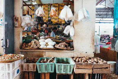 Close-up of a vibrant food market stall featuring fresh produce with crisp parchment notes beside it.