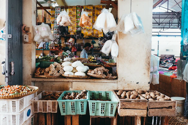 Colorful fresh produce and spices laid out on a vibrant market stall.