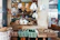 Close-up of a vibrant artisanal food market stall with fresh produce and happy customers.