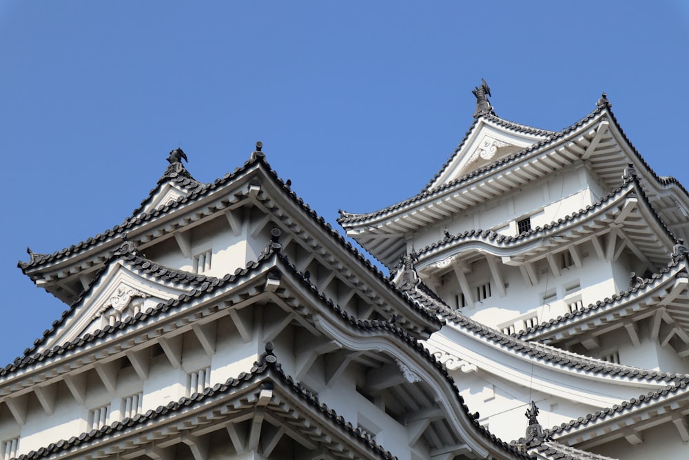 a tall white building with a blue sky in the background