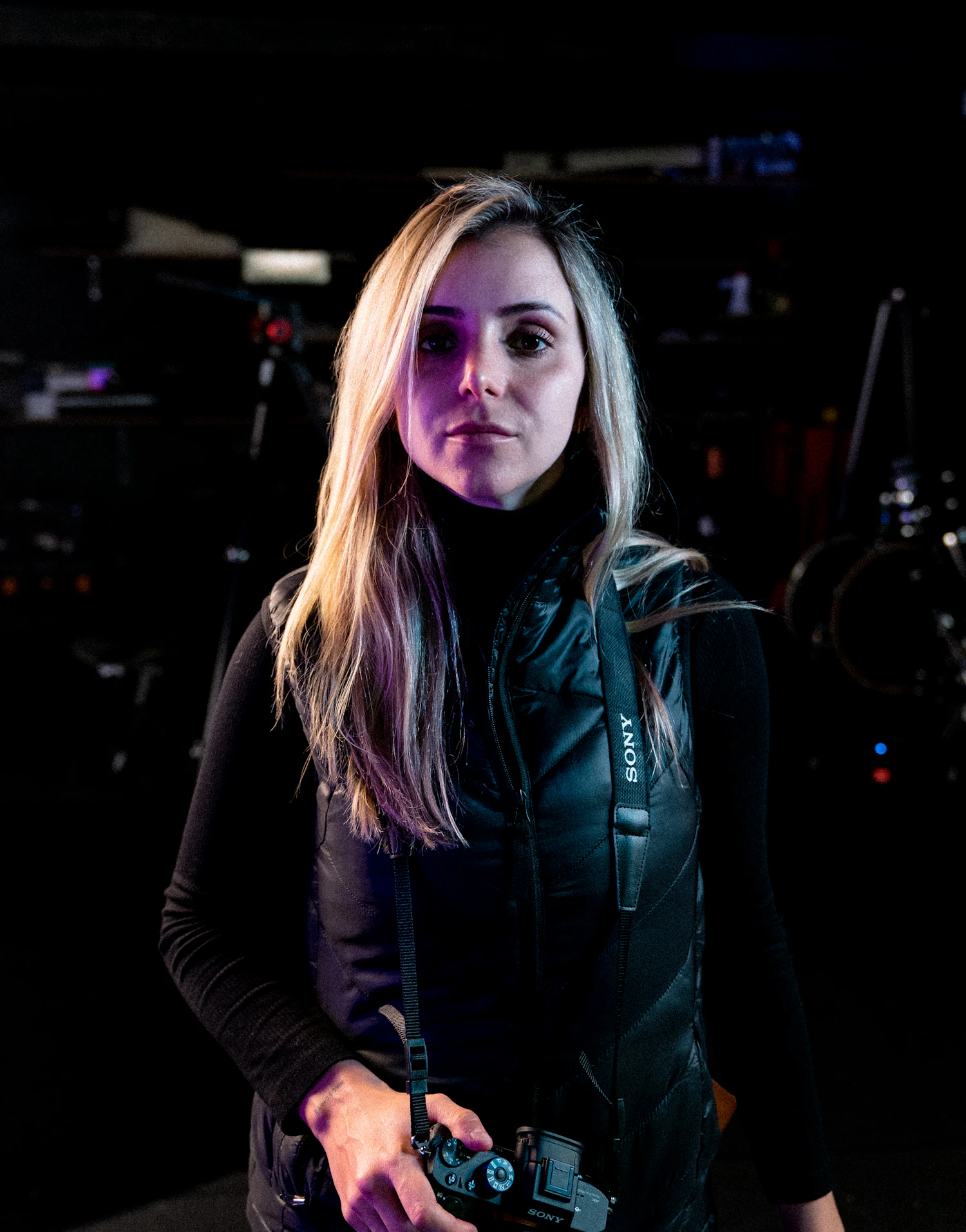 Ola Rzepecka in a dark hall, a camera rig behind her shoulder