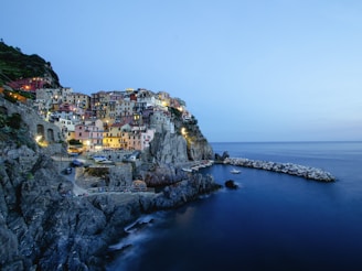 a small village on the edge of a cliff next to the ocean
