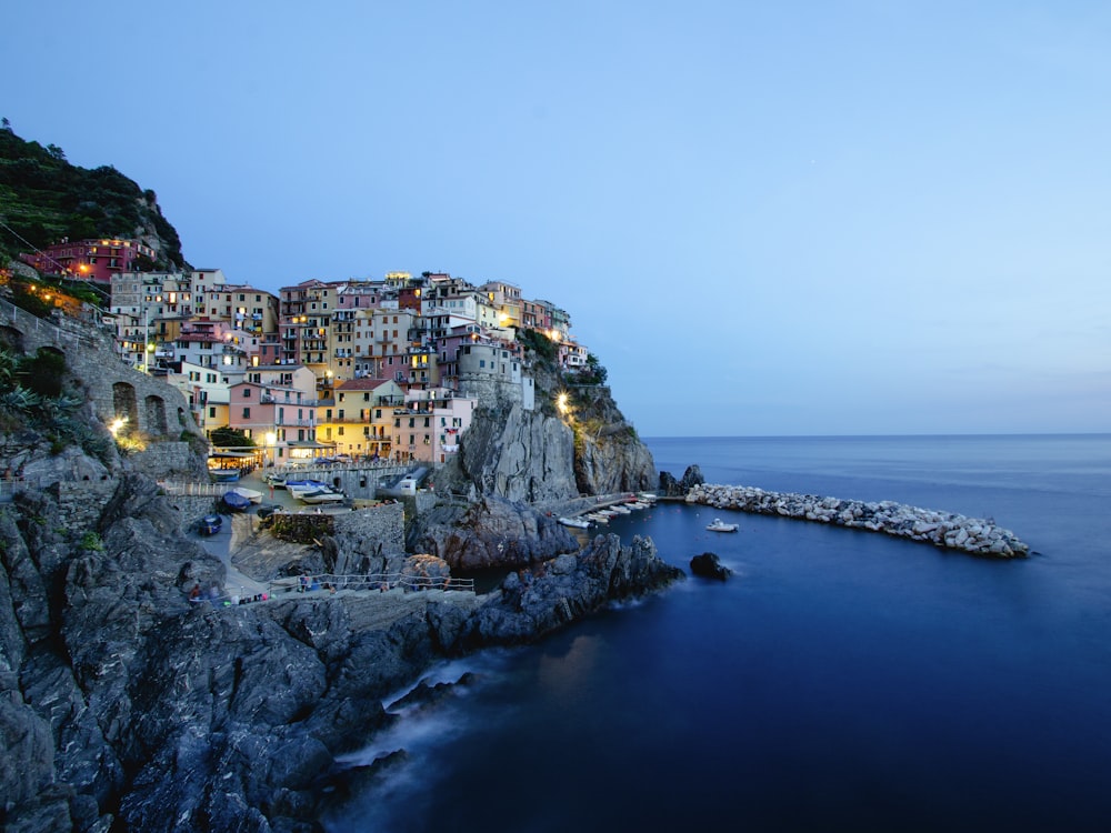 a small village on the edge of a cliff next to the ocean