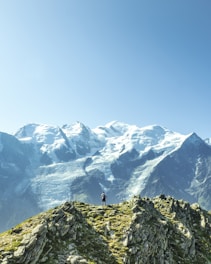 man standing overlooking mountain at daytime