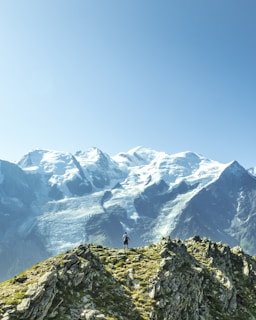 man standing overlooking mountain at daytime