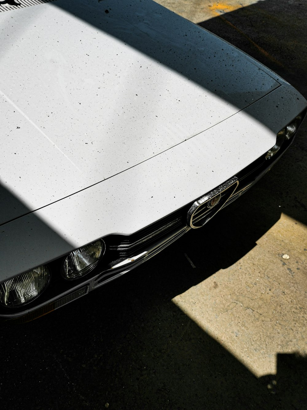 white and black car parked on concrete surface