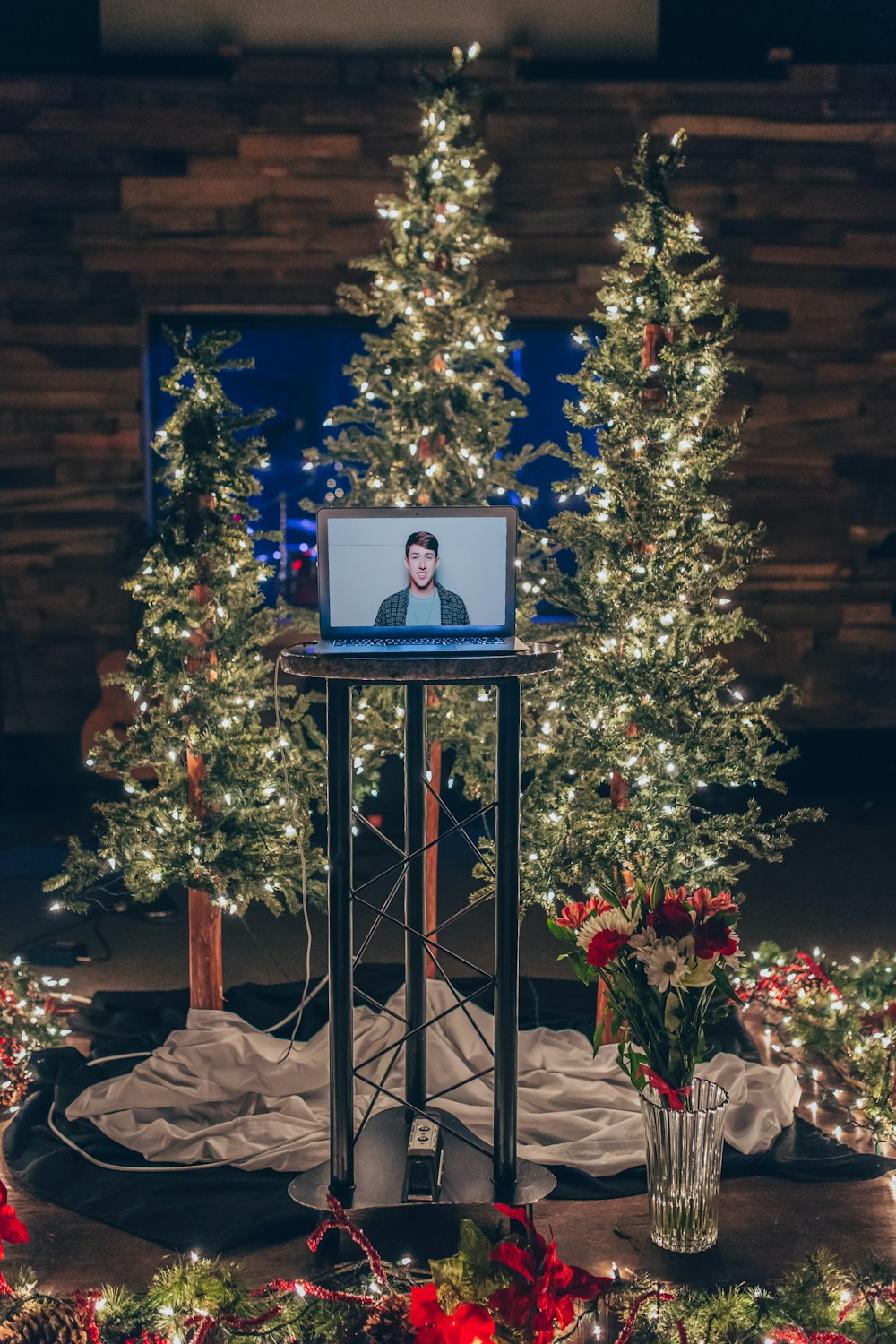 gray monitor turned on near holiday trees
