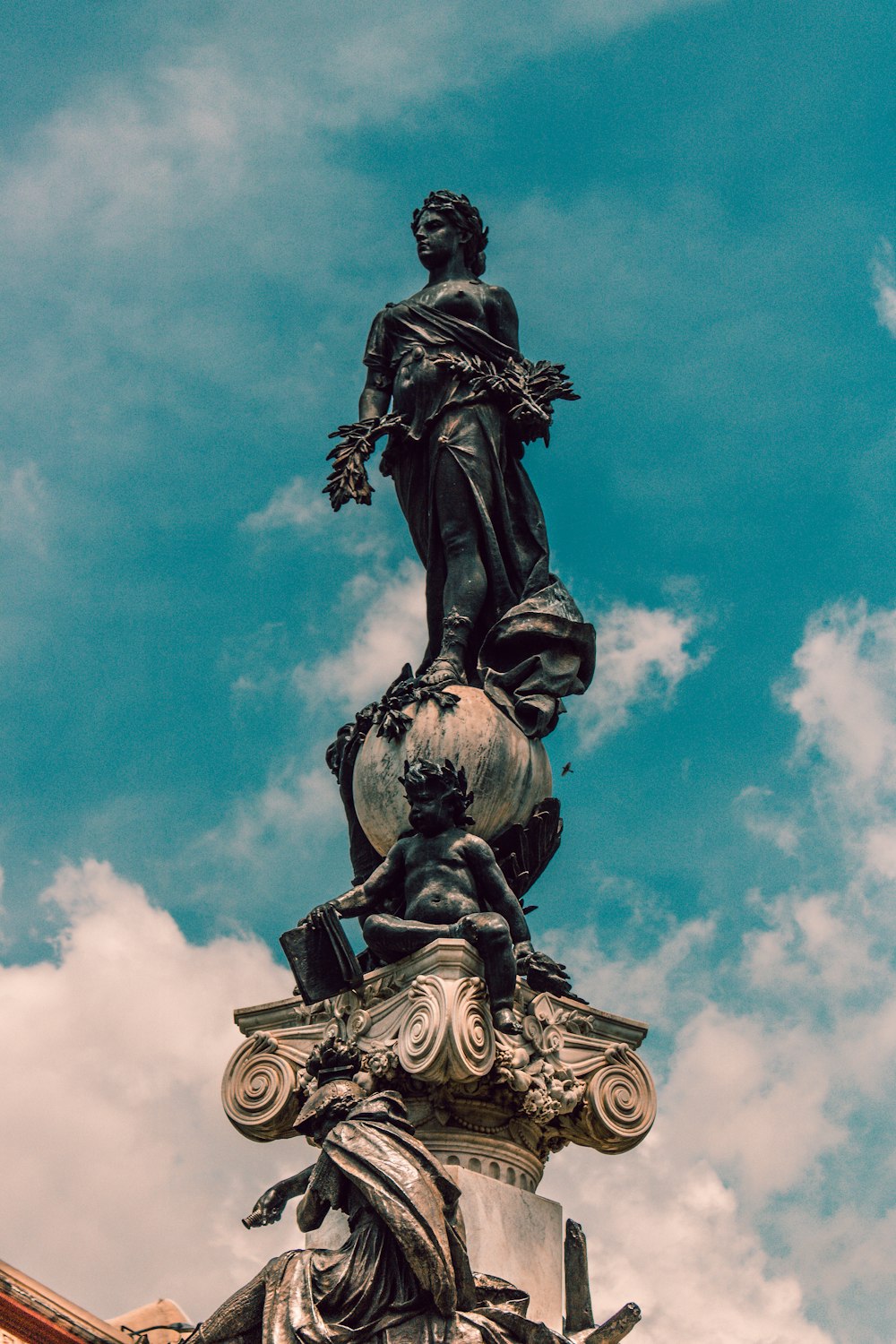 concrete woman statue under cloudy sky