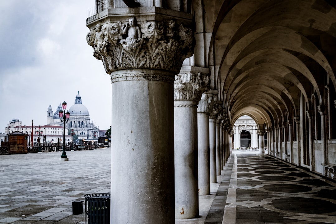 white concrete buildings at daytime, Cloudy sunrise in Venice on a deep perspective