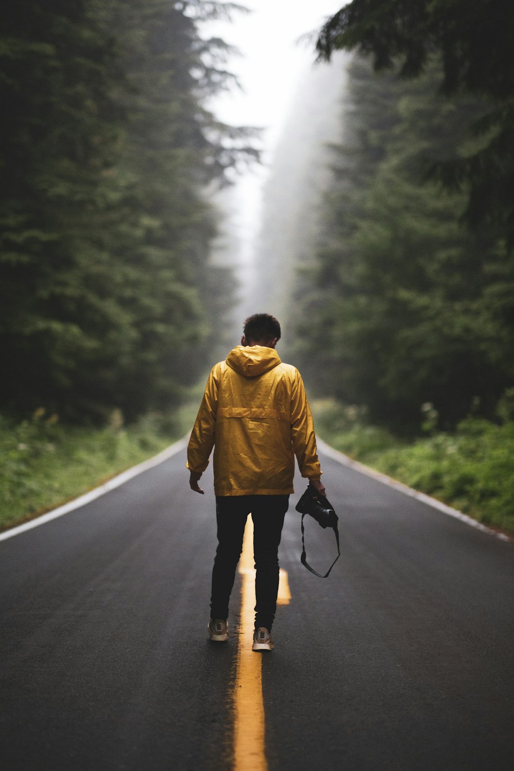 man standing on road during daytime