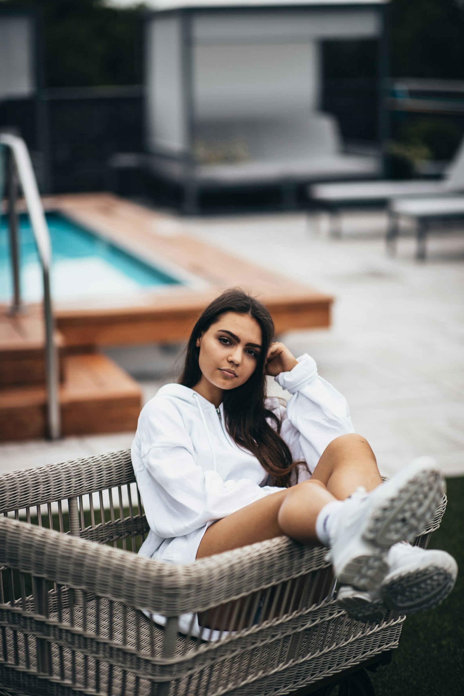 Canon EF 85mm F1.4L IS USM sample photo. Woman sitting near pool photography