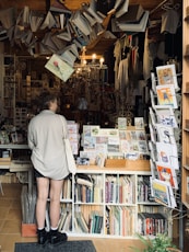 a man standing in front of a book store