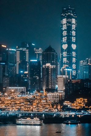 concrete buildings beside body of water during nighttime