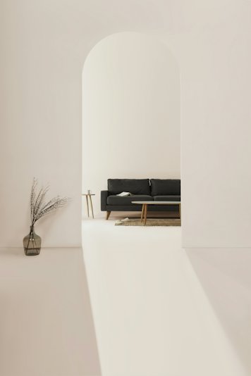 A minimal interior in pale tones under soft light &mdash; stock photograph, not one of the lodge&rsquo;s rooms