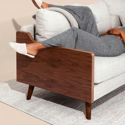 woman relaxing on sofa in loungewear, symbolizing real-life weight loss without the gym