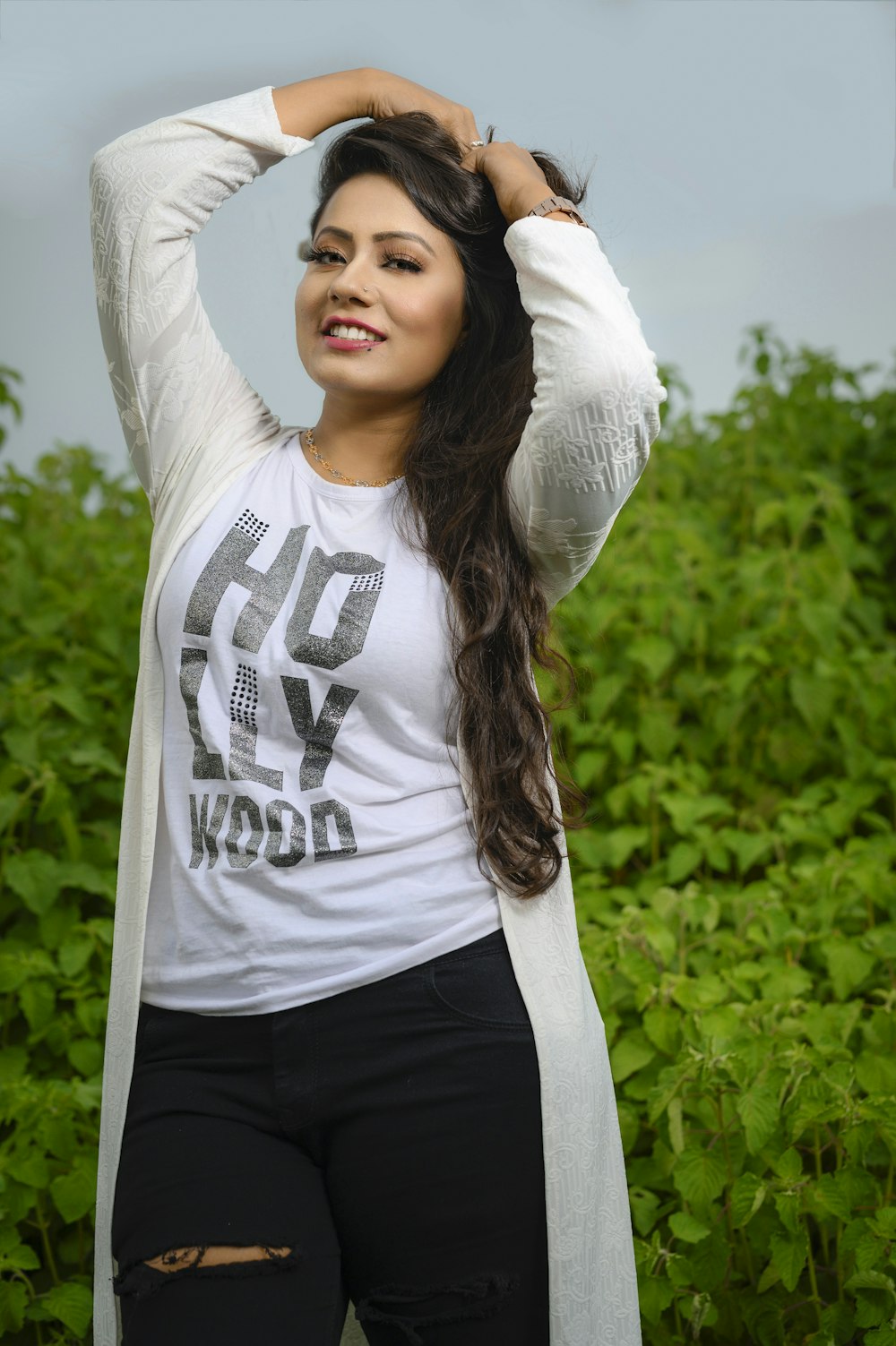 smiling woman wearing white long cardigan