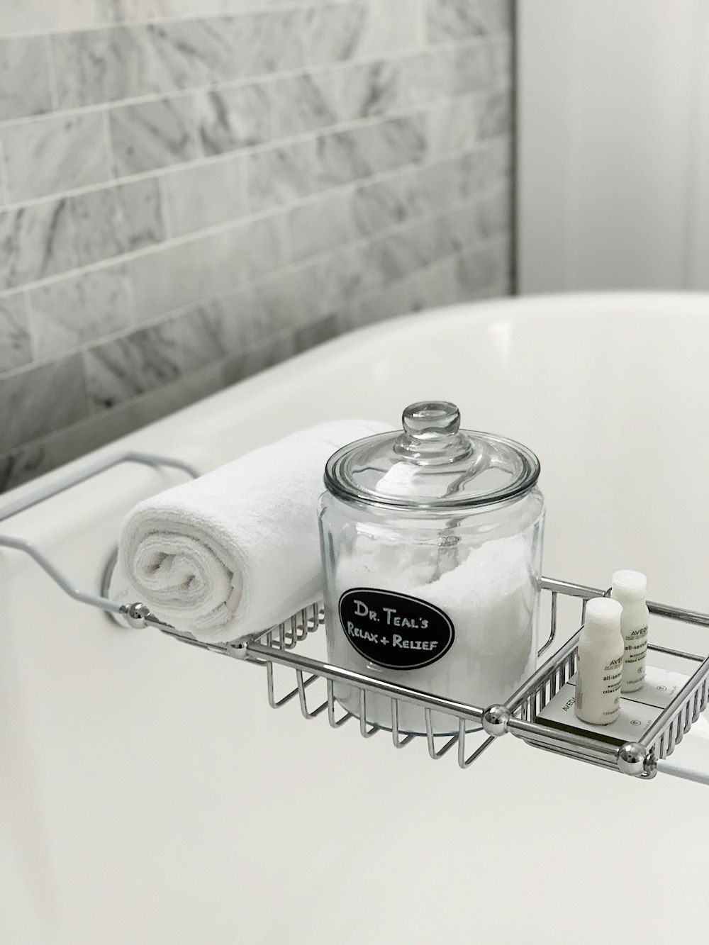 clear glass container with lid beside towel