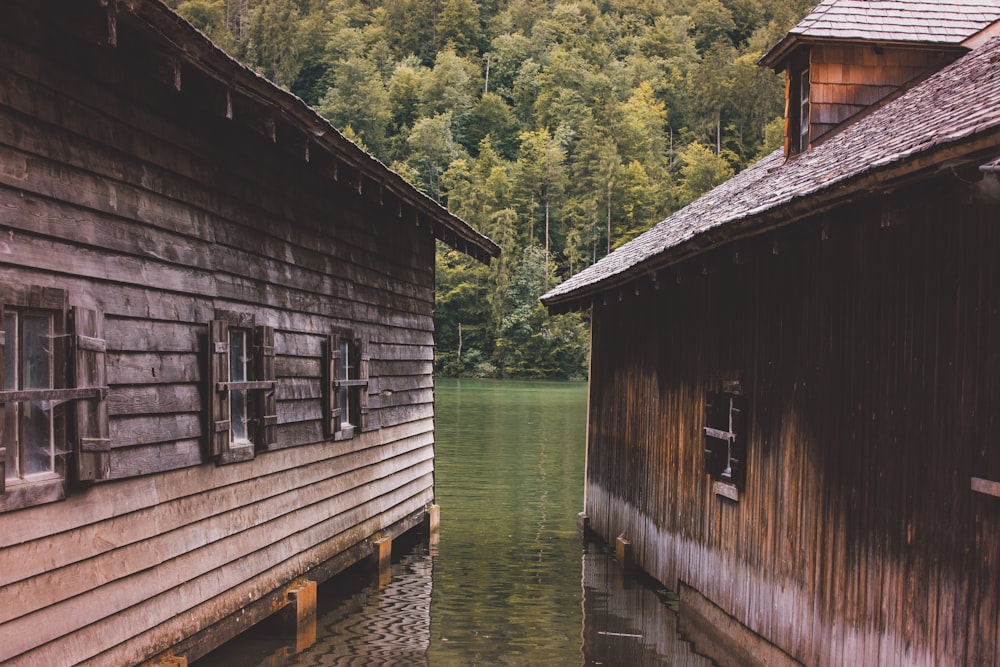 a couple of buildings sitting next to a body of water