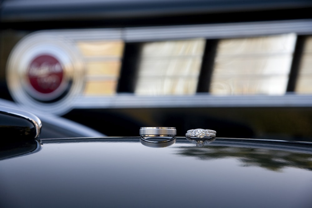 two silver rings on black surface