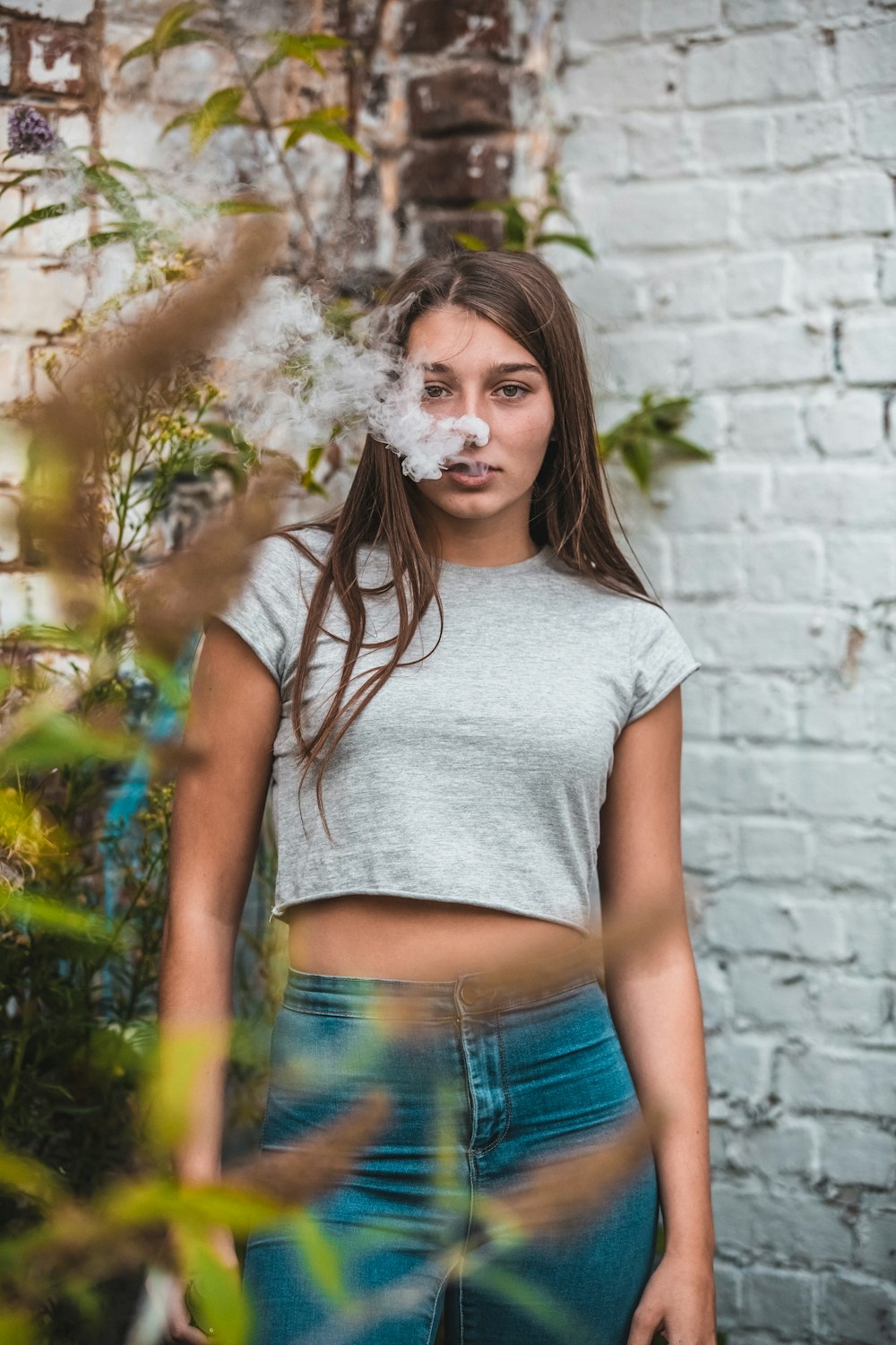 woman wearing grey crop top and blue bottoms