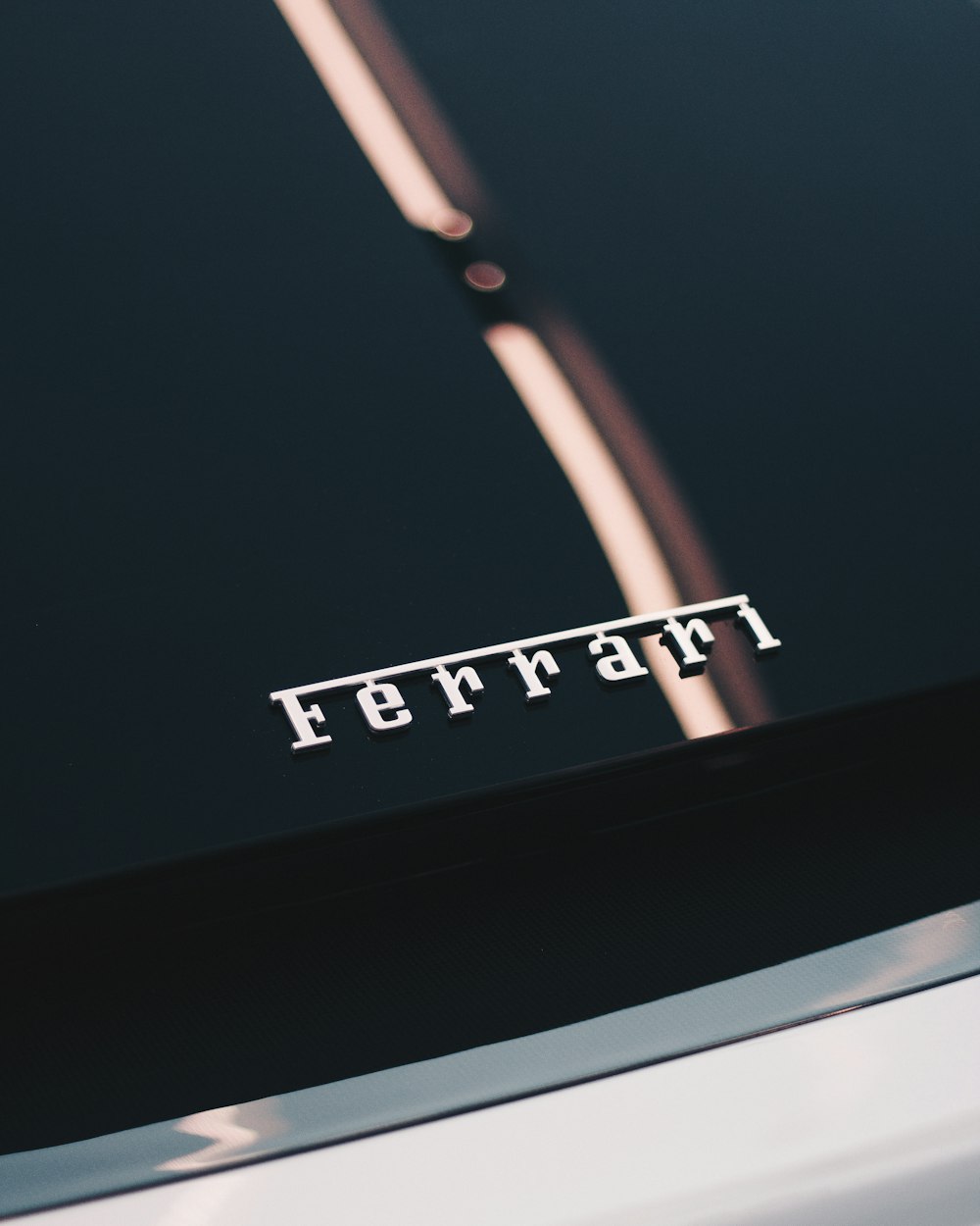 white Ferrari metal logo