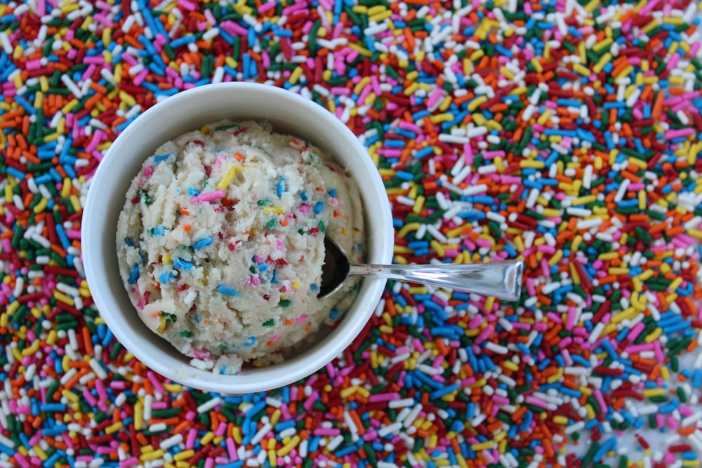 a bowl of ice cream surrounded by sprinkles