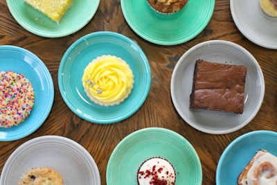 A colorful assortment of healthy fit desserts arranged on a rustic wooden table.