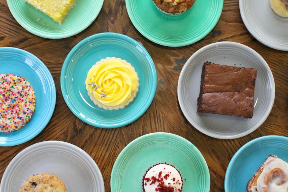 a table topped with lots of different types of cakes