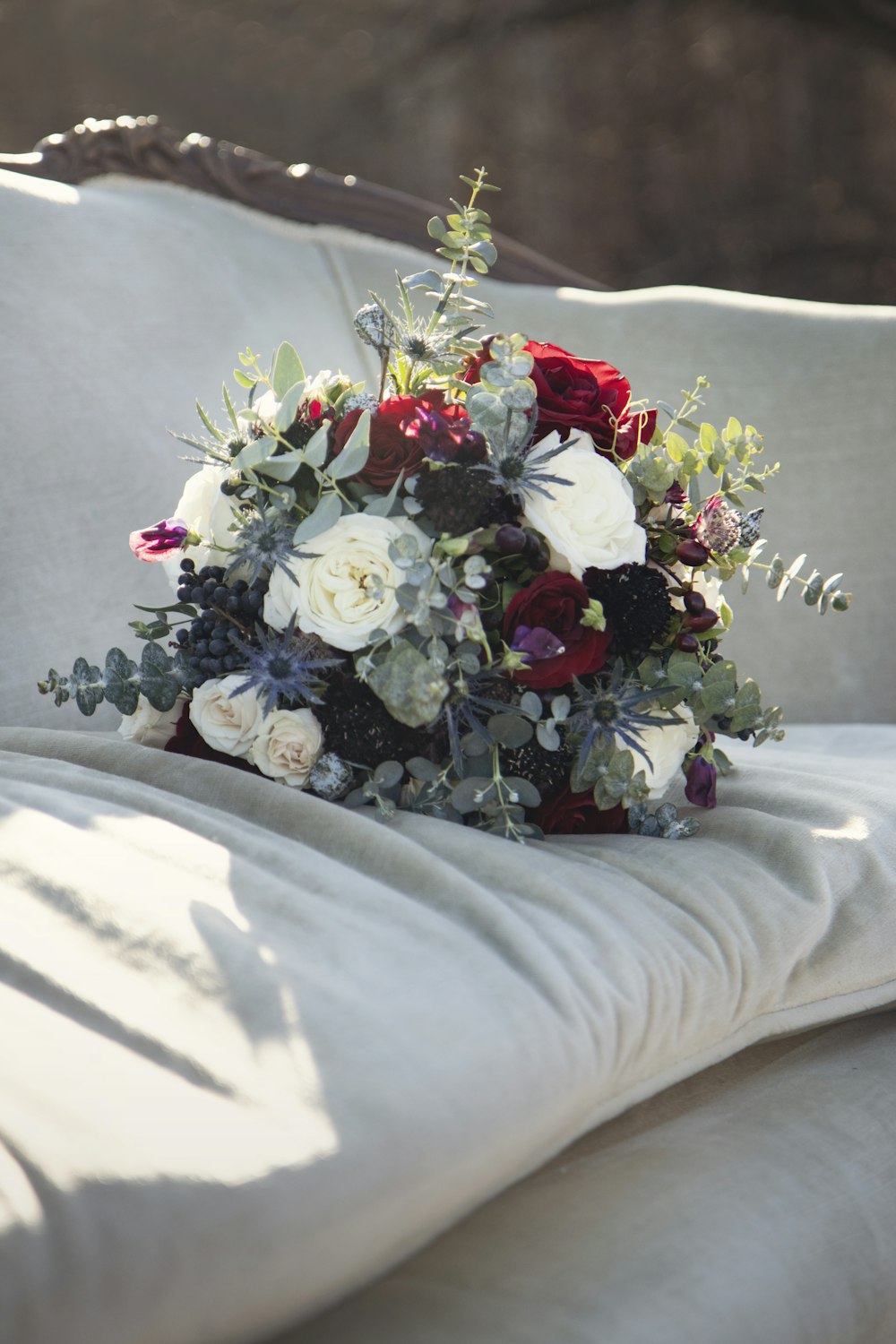 a bouquet of flowers is laying on a couch