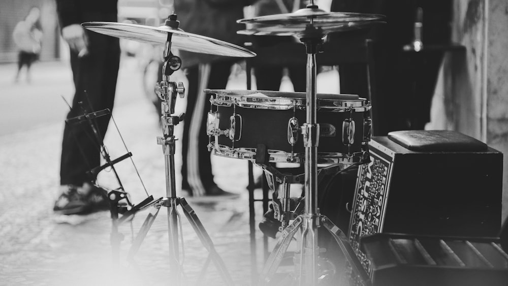 acoustic drum kit near standing people