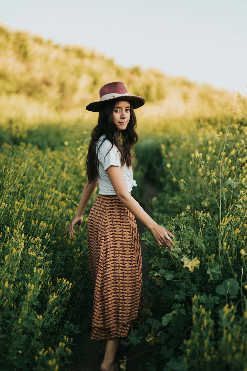 woman standing beside flowers