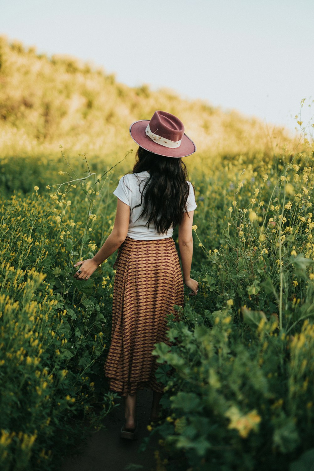 woman standing beside flowers