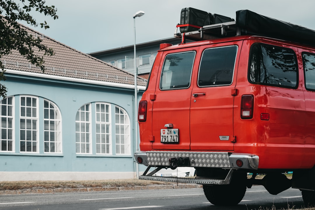 red vehicle near house