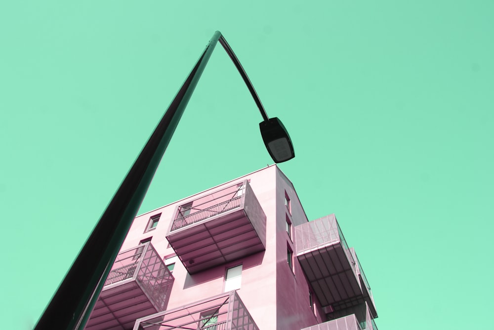 pink building besides black street lamp