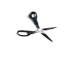 A pair of black-handled scissors has one blade broken off, with the two blades overlapping slightly against a white background.