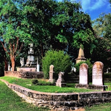 A peaceful cemetery scene with well-maintained headstones and fresh flowers.