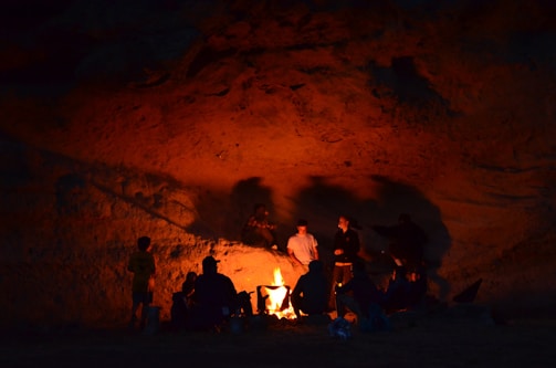 Illustration of a group of adventurers gathered around a flickering campfire