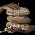 person holding baked bread