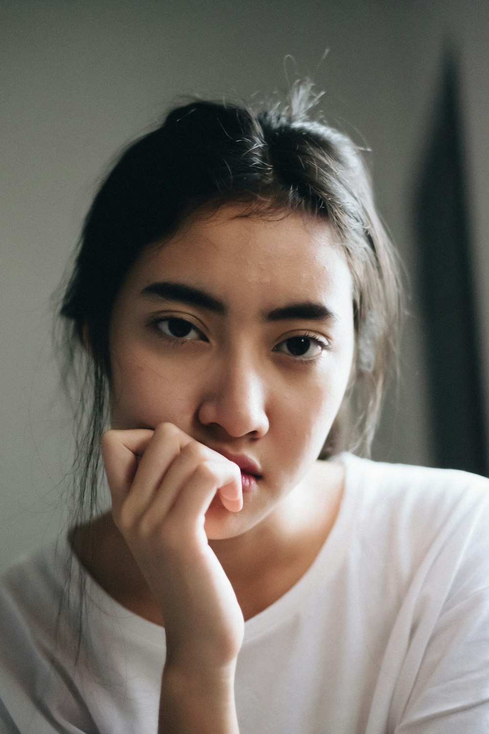 portrait of woman wearing white crew-neck shirt