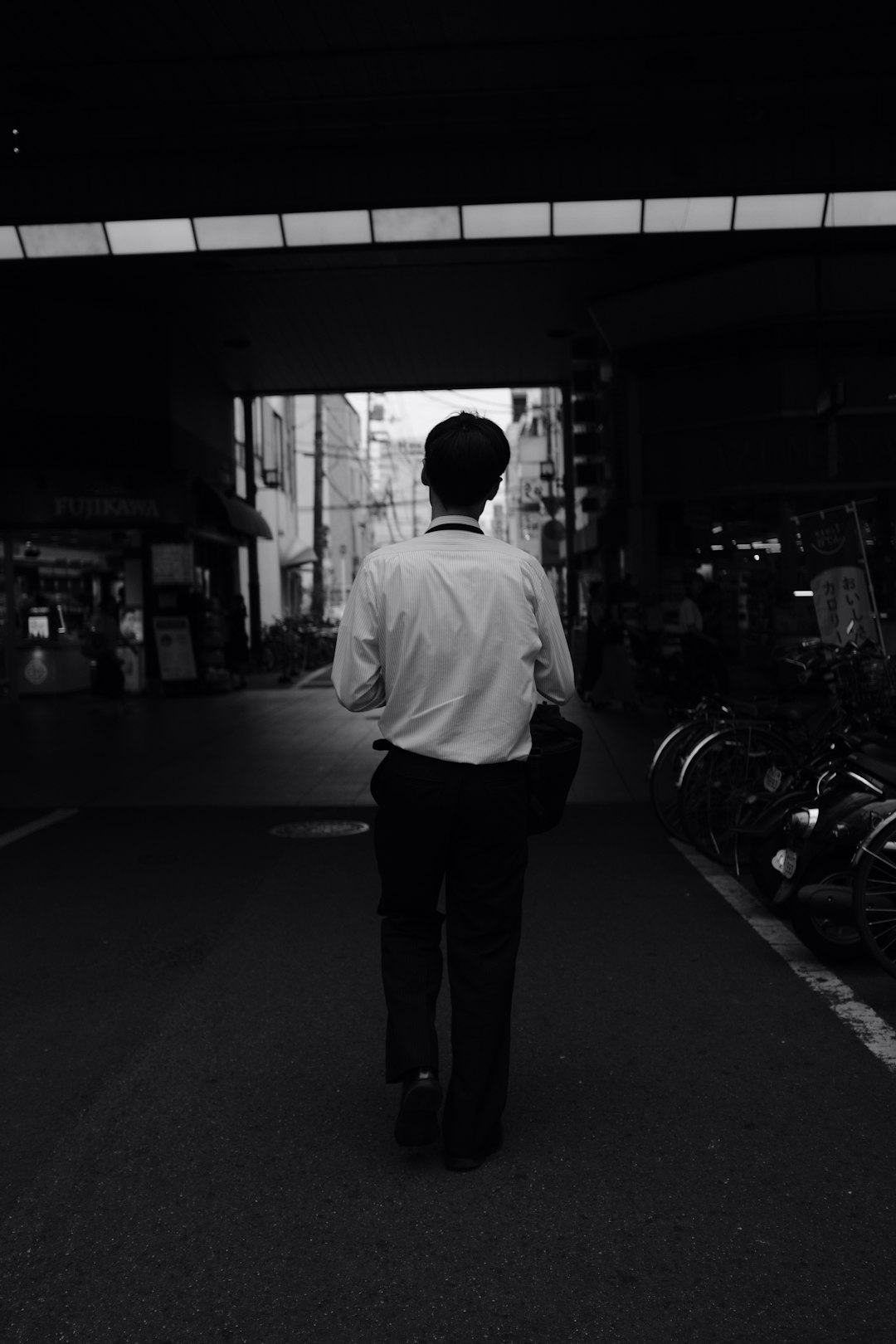 man walking on road during daytime